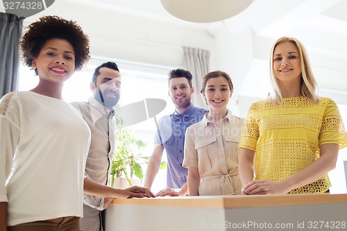 Image of happy creative team in office