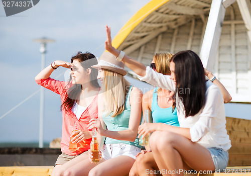 Image of girls with drinks on the beach