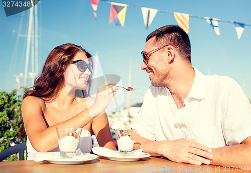 Image of smiling couple eating dessert at cafe