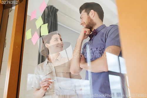 Image of happy creative team talking at office