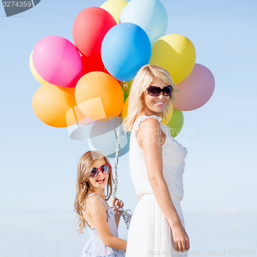 Image of mother and child with colorful balloons