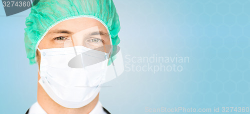 Image of male surgeon face in medical cap and mask