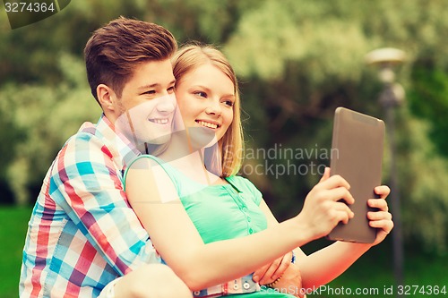 Image of smiling couple with tablet pc making selfie