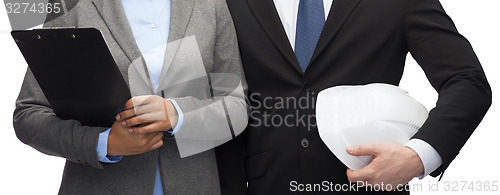 Image of businesspeople with clipboard and helmet