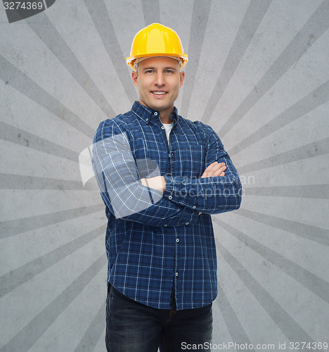 Image of smiling male builder or manual worker in helmet