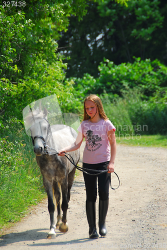 Image of Girl walk pony