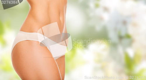 Image of close up of slim woman tummy and hips in underwear