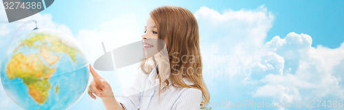 Image of smiling student girl with globe at school