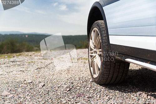 Image of close up of dirty car wheel on cliff