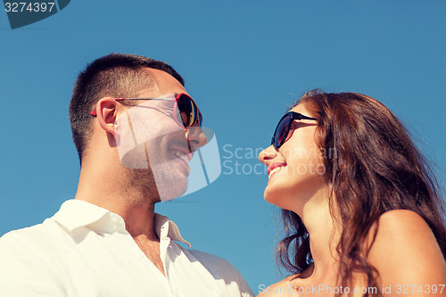 Image of smiling couple over blue sky background