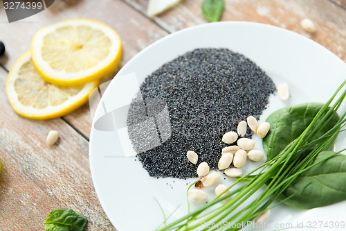 Image of close up of peeled peanuts, greens and chia seeds