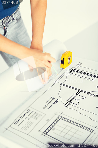 Image of architect drawing on blueprint