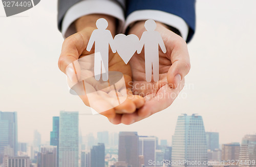 Image of close up of male gay couple with love symbol