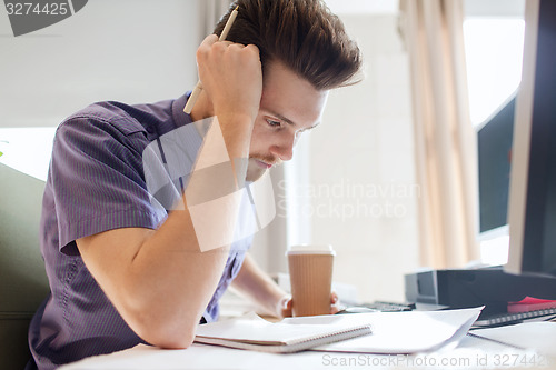 Image of creative male office worker with coffee thinking