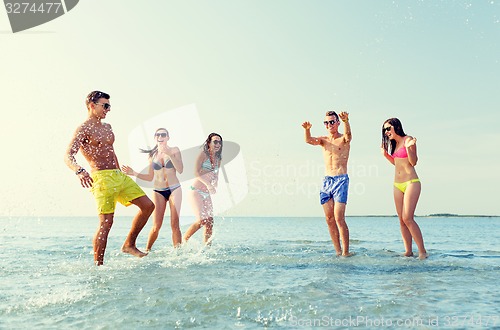 Image of happy friends having fun on summer beach