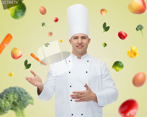 Image of happy male chef cook inviting