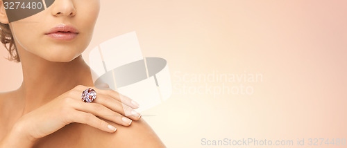 Image of close up of woman with cocktail ring on hand