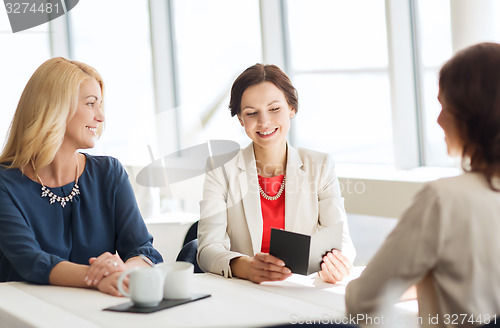 Image of happy women looking at restaurant bill