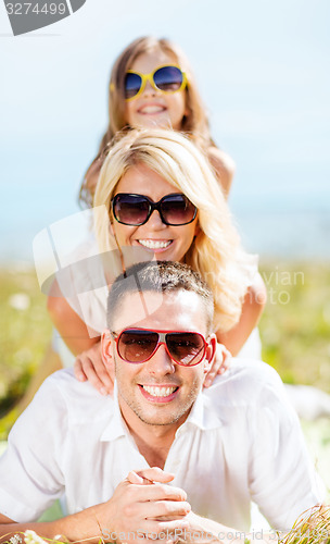 Image of happy family with blue sky and green grass