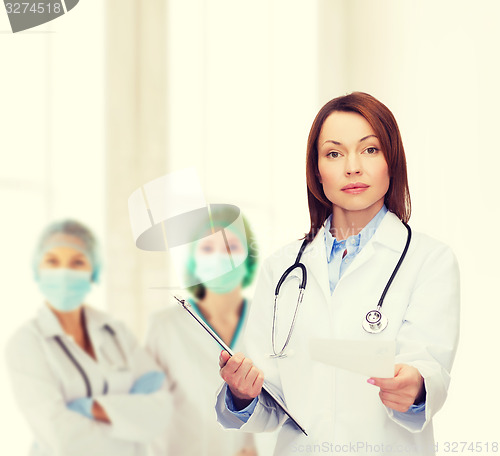 Image of calm female doctor with clipboard