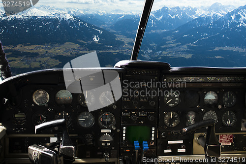 Image of dashboard in airplane cockpit and mountains view