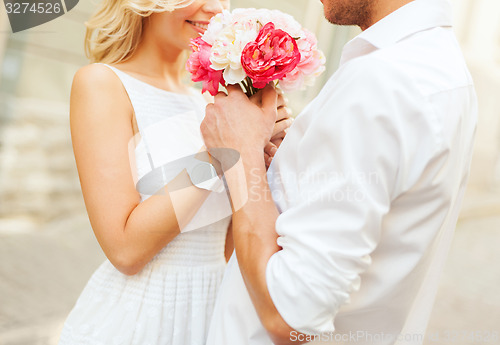 Image of couple with flowers in the city