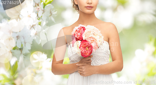 Image of bride or woman with bouquet of flowers