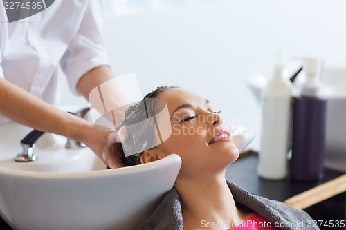 Image of happy young woman at hair salon