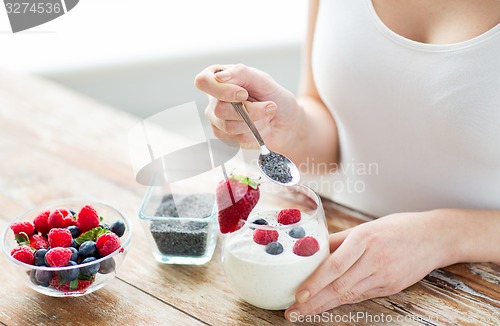 Image of close up of woman hands with yogurt and berries