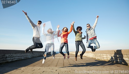 Image of smiling friends in sunglasses laughing on street