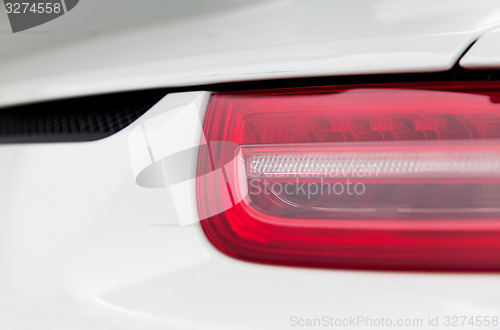 Image of close up of car part with grille and headlight