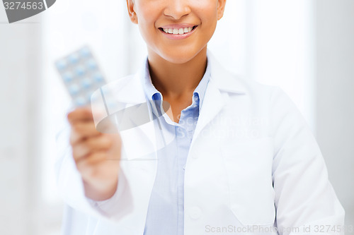 Image of doctor with blister packs of pills