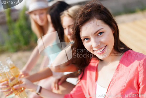 Image of girl with drink on the beach