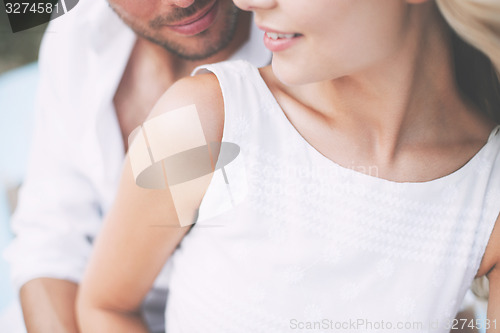 Image of couple in shades at sea side