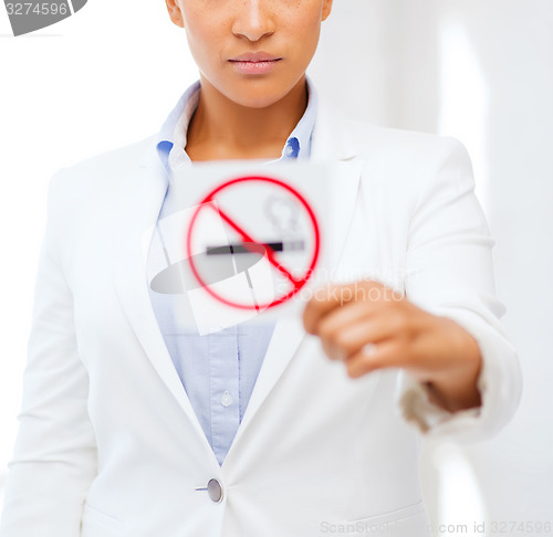 Image of african woman with restriction no smoking sign