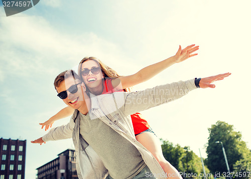 Image of smiling couple having fun in city