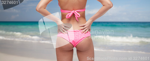 Image of close up of woman buttocks in bikini over beach