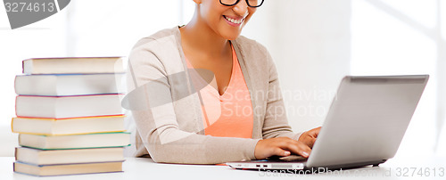 Image of international student girl with laptop at school