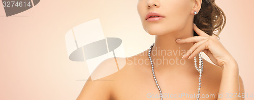 Image of woman with pearl earrings and necklace