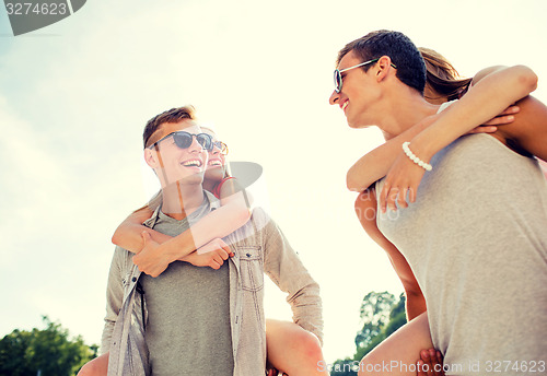 Image of smiling couple having fun in city