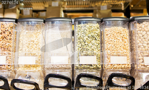 Image of row of jars with nuts and seeds at grocery store