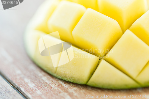 Image of close up of ripe mango slice on table