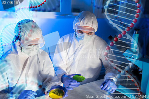 Image of close up of scientists with test samples in lab