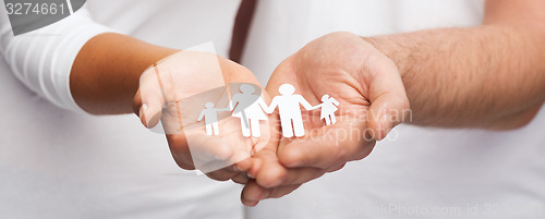 Image of couple hands with paper man family