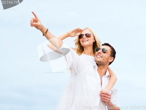 Image of couple in shades at sea side