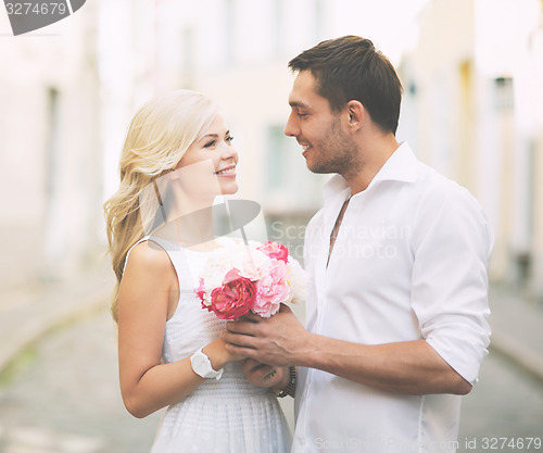 Image of couple with flowers in the city