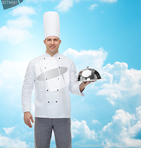 Image of happy male chef cook holding cloche