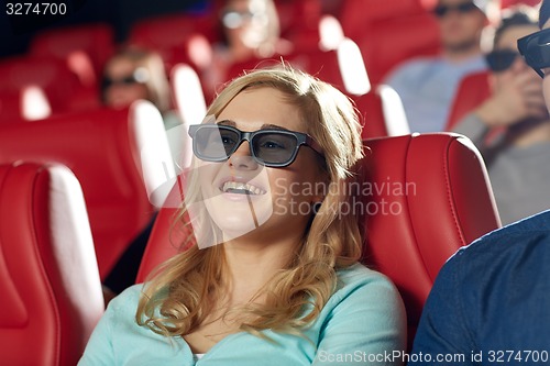 Image of happy young woman watching movie in theater