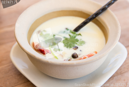 Image of bowl of creamy soup with shrimps on table