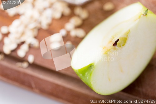 Image of close up of green apple on wooden cutting board
